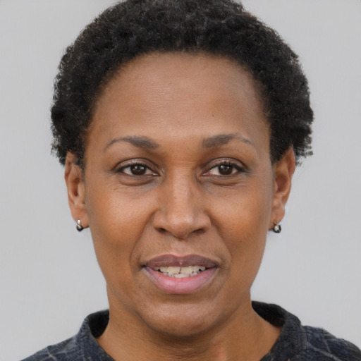Joyful latino adult female with short  brown hair and brown eyes