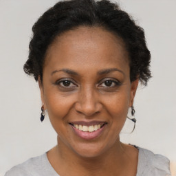 Joyful black adult female with short  brown hair and brown eyes