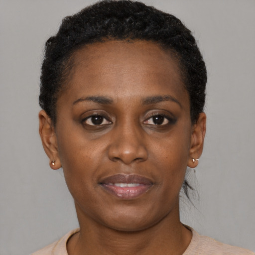 Joyful black young-adult female with short  brown hair and brown eyes