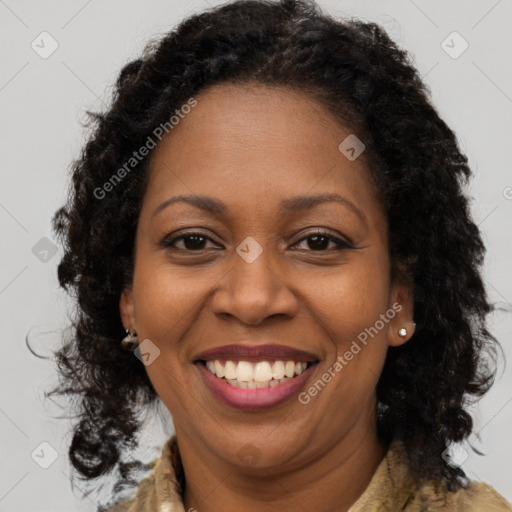 Joyful black adult female with long  brown hair and brown eyes