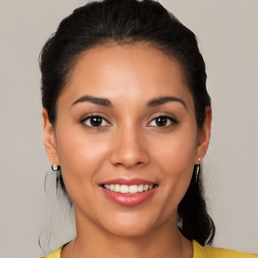 Joyful latino young-adult female with short  black hair and brown eyes