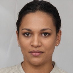 Joyful latino young-adult female with short  brown hair and brown eyes