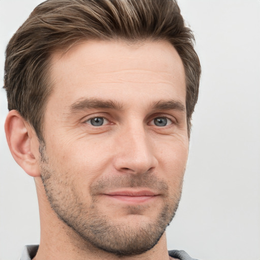 Joyful white adult male with short  brown hair and grey eyes