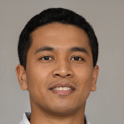 Joyful asian young-adult male with short  black hair and brown eyes