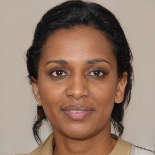 Joyful black young-adult female with medium  black hair and brown eyes