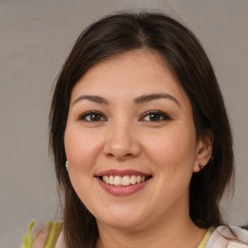 Joyful white young-adult female with medium  brown hair and brown eyes