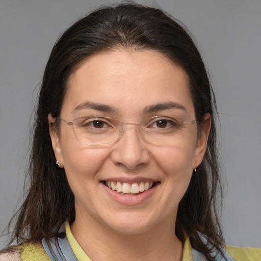 Joyful white adult female with medium  brown hair and brown eyes