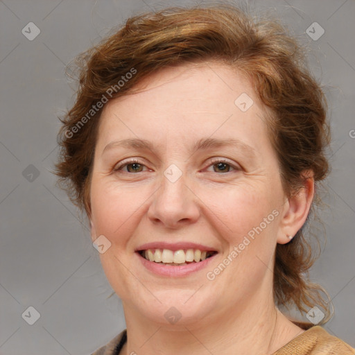 Joyful white adult female with medium  brown hair and blue eyes