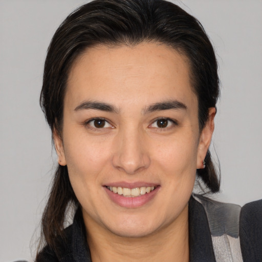 Joyful white young-adult female with medium  brown hair and brown eyes