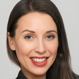 Joyful white adult female with long  brown hair and brown eyes