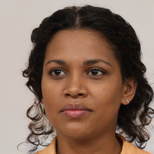Joyful black young-adult female with medium  brown hair and brown eyes