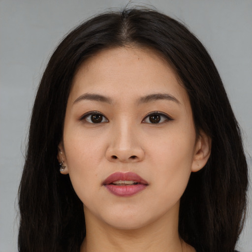 Joyful asian young-adult female with long  brown hair and brown eyes