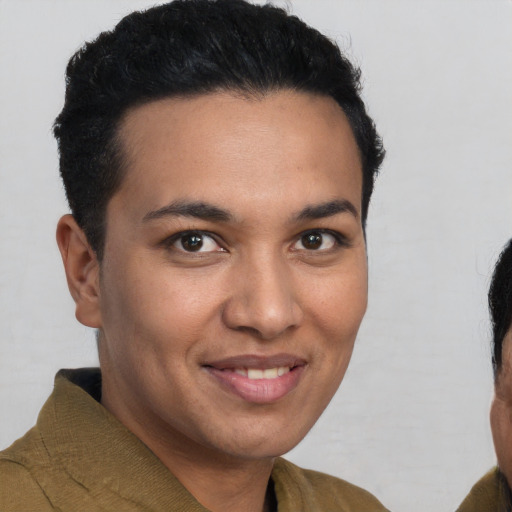 Joyful latino young-adult male with short  brown hair and brown eyes