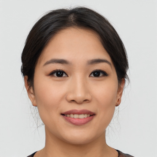 Joyful asian young-adult female with medium  brown hair and brown eyes