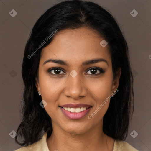 Joyful black young-adult female with long  black hair and brown eyes