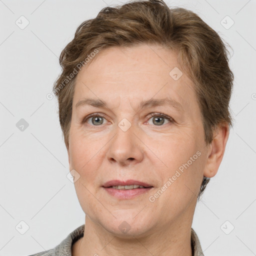 Joyful white adult female with short  brown hair and grey eyes