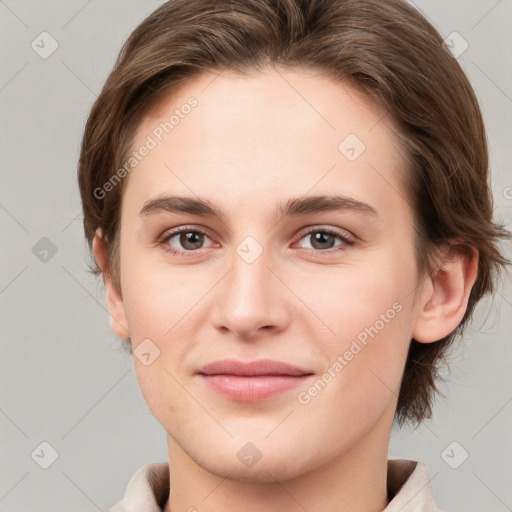 Joyful white young-adult female with medium  brown hair and grey eyes