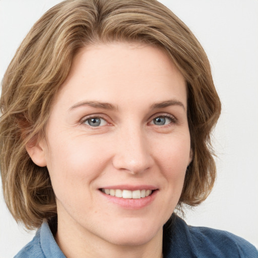 Joyful white young-adult female with medium  brown hair and blue eyes