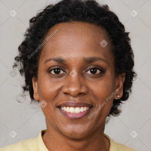 Joyful black adult female with short  brown hair and brown eyes