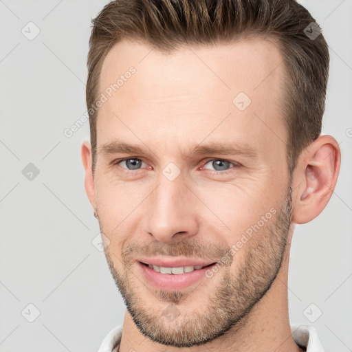 Joyful white adult male with short  brown hair and grey eyes