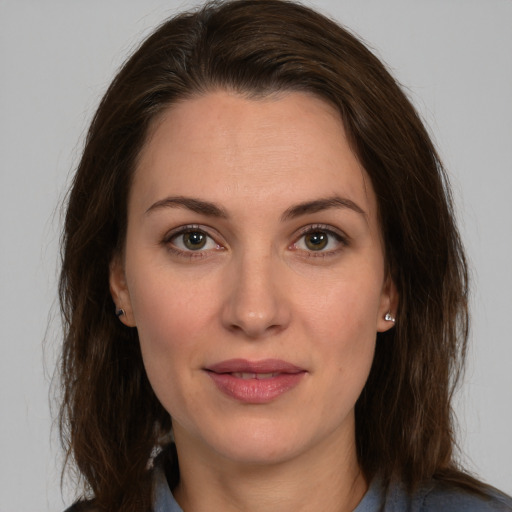 Joyful white young-adult female with long  brown hair and brown eyes