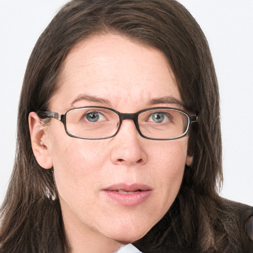 Joyful white adult female with long  brown hair and green eyes