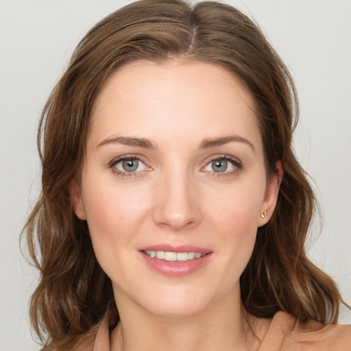 Joyful white young-adult female with medium  brown hair and green eyes