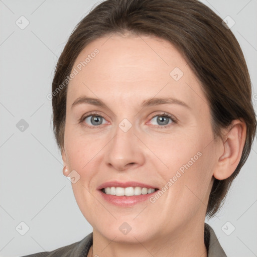 Joyful white young-adult female with medium  brown hair and grey eyes