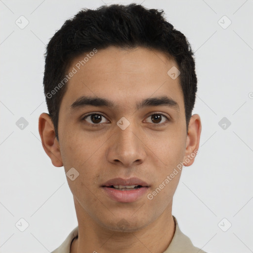 Joyful latino young-adult male with short  brown hair and brown eyes