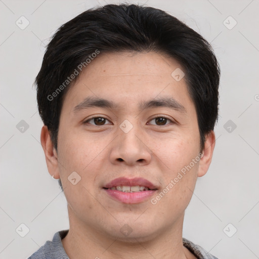 Joyful asian young-adult male with short  brown hair and brown eyes