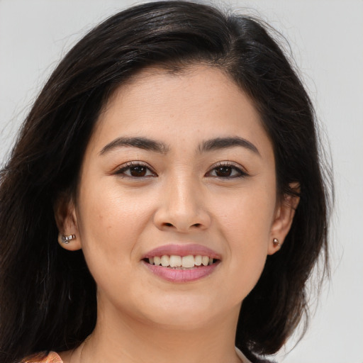 Joyful white young-adult female with long  brown hair and brown eyes