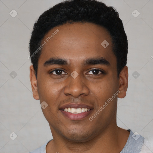 Joyful black young-adult male with short  black hair and brown eyes