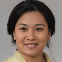 Joyful asian young-adult female with medium  brown hair and brown eyes