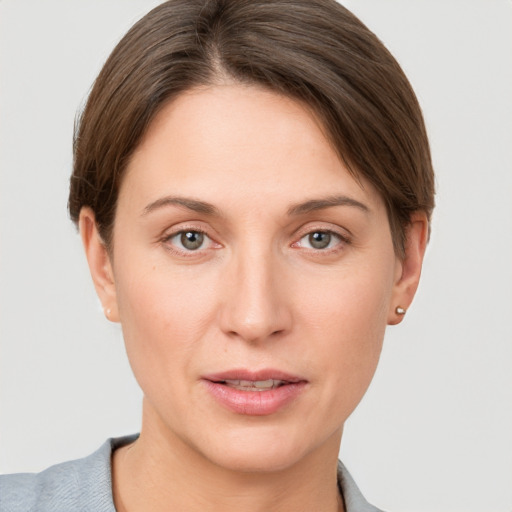 Joyful white young-adult female with short  brown hair and grey eyes