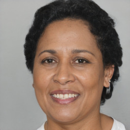 Joyful latino adult female with short  brown hair and brown eyes