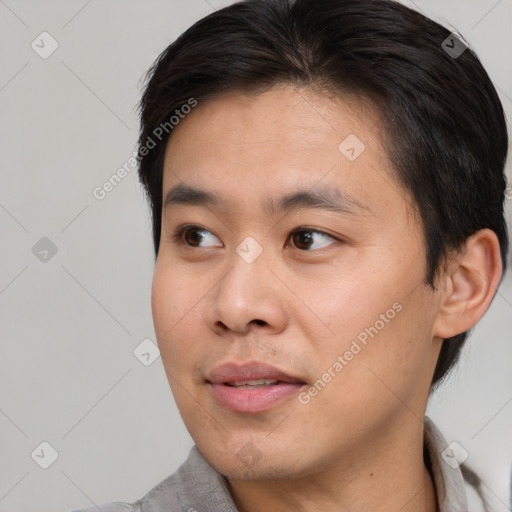 Joyful white young-adult male with short  black hair and brown eyes