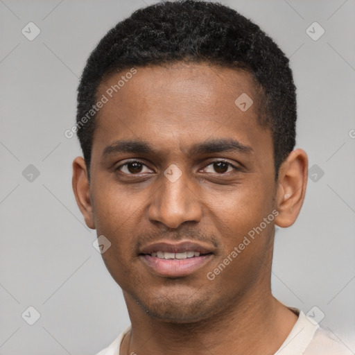 Joyful black young-adult male with short  black hair and brown eyes