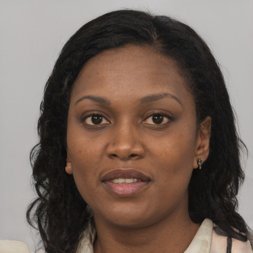 Joyful black young-adult female with long  black hair and brown eyes