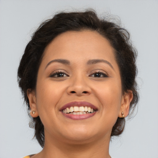 Joyful latino young-adult female with medium  brown hair and brown eyes