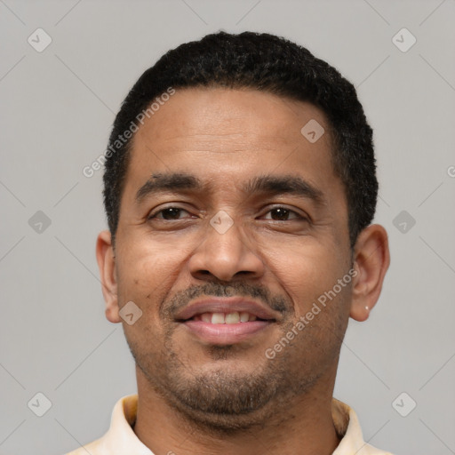 Joyful latino adult male with short  black hair and brown eyes