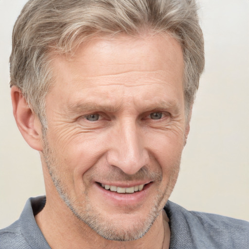 Joyful white middle-aged male with short  brown hair and grey eyes