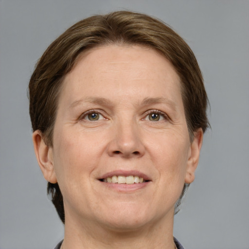 Joyful white adult female with short  brown hair and grey eyes