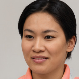 Joyful asian young-adult female with medium  brown hair and brown eyes