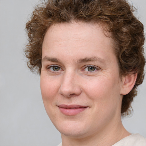 Joyful white young-adult female with medium  brown hair and green eyes