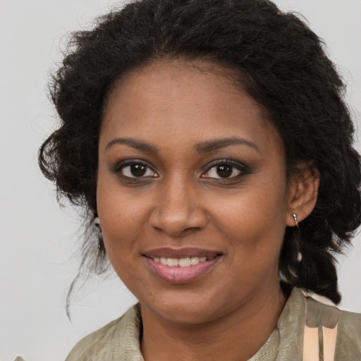 Joyful black young-adult female with medium  brown hair and brown eyes