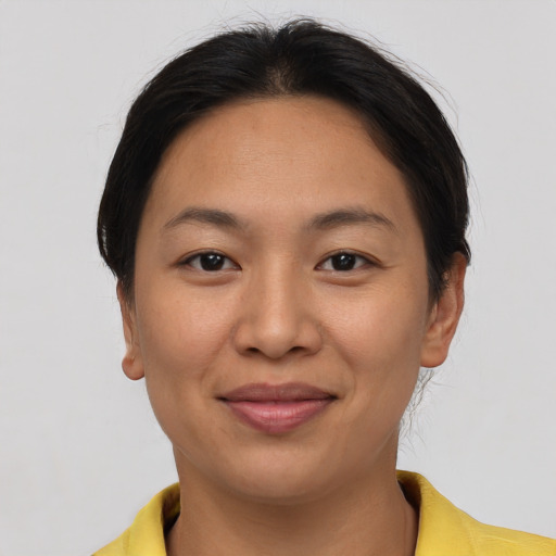 Joyful asian young-adult female with short  brown hair and brown eyes