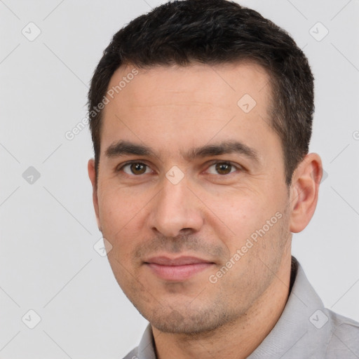 Joyful white young-adult male with short  black hair and brown eyes