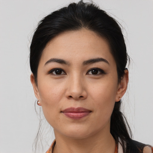 Joyful asian young-adult female with long  black hair and brown eyes