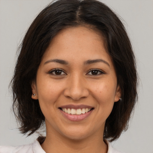 Joyful white young-adult female with medium  brown hair and brown eyes