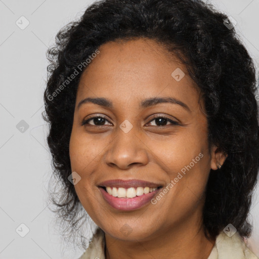 Joyful black young-adult female with long  brown hair and brown eyes